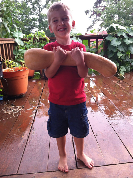 Sweet Kid holding a giant squash